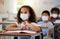 School student with covid learning in class, wearing mask to protect from virus and looking concentrated on education in