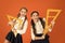 School students learning geometry. Kids school uniform on orange background. Pupil cute girls with big rulers. Geometry