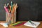 School supplies on blackboard background . The concept of education, study, learning, elearning. Back to schoolSchool supplies on