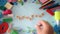 School supplies on the blue background with text September . Woman hand put a supples on the table