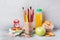 School supplies and Breakfast crackers, orange juice and fresh Apple on the grey table with copy space. concept school