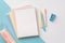 School supplies concept. Top view photo of colorful stationery open notebook pens pencil-case and mini stapler on bicolor blue and