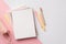 School supplies concept. Top view photo of pink and yellow stationery stack of planners pens and pencil-case on bicolor pink and