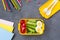 School supplies and lunch box with sandwich and vegetables. Back to school. Healthy eating habits concept - background layout with