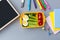 School supplies and lunch box with sandwich and vegetables. Back to school. Healthy eating habits concept - background layout with