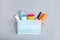 School supplies with medical face mask on a gray background. Protection of schoolchildren and students from the coronavirus covid-