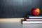 School supplies on old wooden table, near blackboard, close up