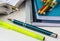 School supplies, stationery, multicolored pencils, pen, highlighter, opened math workbook on white desktop, learning, studying