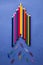 School supplies top view rocket shape - colour pencils, clips - on blue background.