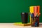 School supplies on wooden desk against green chalkboard