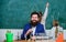 School teacher of biology. Man bearded teacher work with microscope and test tubes in biology classroom. Biology plays