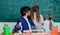 School teacher of biology. Man bearded teacher work with microscope and test tubes in biology classroom. Explaining