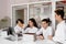 School teacher gives chemistry lesson to children in a laboratory with flasks with liquids for experiments. Education