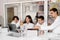 School teacher gives chemistry lesson to children in a laboratory with flasks with liquids for experiments. Education