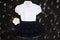School uniform with white shirt, socks and dark denim skirt on a black background. Flatlay, top view, copy space