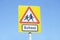 School warning sign blue sky red triangle road safety children young kids parent