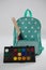 Schoolbag with various supplies and palette