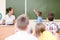 Schoolboy answers questions of teachers near a school board
