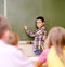 Schoolboy answers questions of teachers near a school board