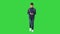 Schoolboy with a backpack using mobile phone while walking on a Green Screen, Chroma Key.