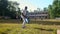 Schoolboy bats flying ball on cricket autumn game slow