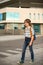 A schoolboy blond, wearing in a shirt and jeans, walks with a kn