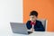 schoolboy boy sitting at a laptop at a desk in a school in a classroom online education room