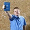 Schoolboy with the certificate about completion of education at school
