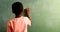 Schoolboy doing mathematics on chalkboard in classroom 4k