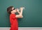 Schoolboy drink water from bottle near a blackboard, empty space, education concept