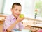 Schoolboy eating an apple