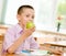 Schoolboy eating an apple