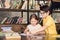 Schoolboy in eyeglasses helping classmate in doing homework