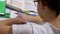 Schoolboy in Glasses Writes with Pen in Notebook Does Homework Use Smartphone