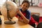 Schoolboy with globe looking at camera in a classroom