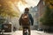 A schoolboy guy with a backpack rides a bike through the city streets. Rear view. A teenage student goes to school