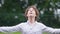 Schoolboy has fun in the warm summer rain. Close portrait curly boy in white shirt, happy childhood