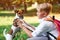 Schoolboy and his dog walking in the park. Friendship, animals and lifestyle