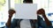 Schoolboy holding blank placard in classroom