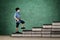 Schoolboy holding a book on books stair