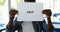 Schoolboy holding placard with text help in classroom