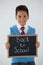 Schoolboy holding writing slate with text back to school against white background