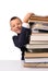 Schoolboy with huge stack of books