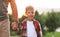 Schoolboy looking at camera with smile while going to first grade in school on sunny autumn day