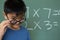 Schoolboy looking over spectacle in a classroom