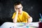 Schoolboy making a colorful drawing at home