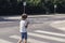 Schoolboy with phone on pedestrian crossing going home