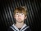 Schoolboy posing in sailor costume with emotions