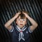 Schoolboy posing in sailor costume with emotions