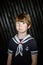 Schoolboy posing in sailor costume with emotions